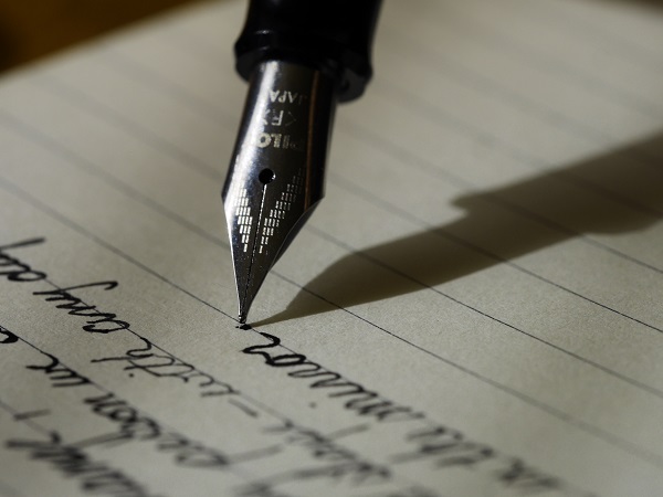 A fountain pen writing a letter. 